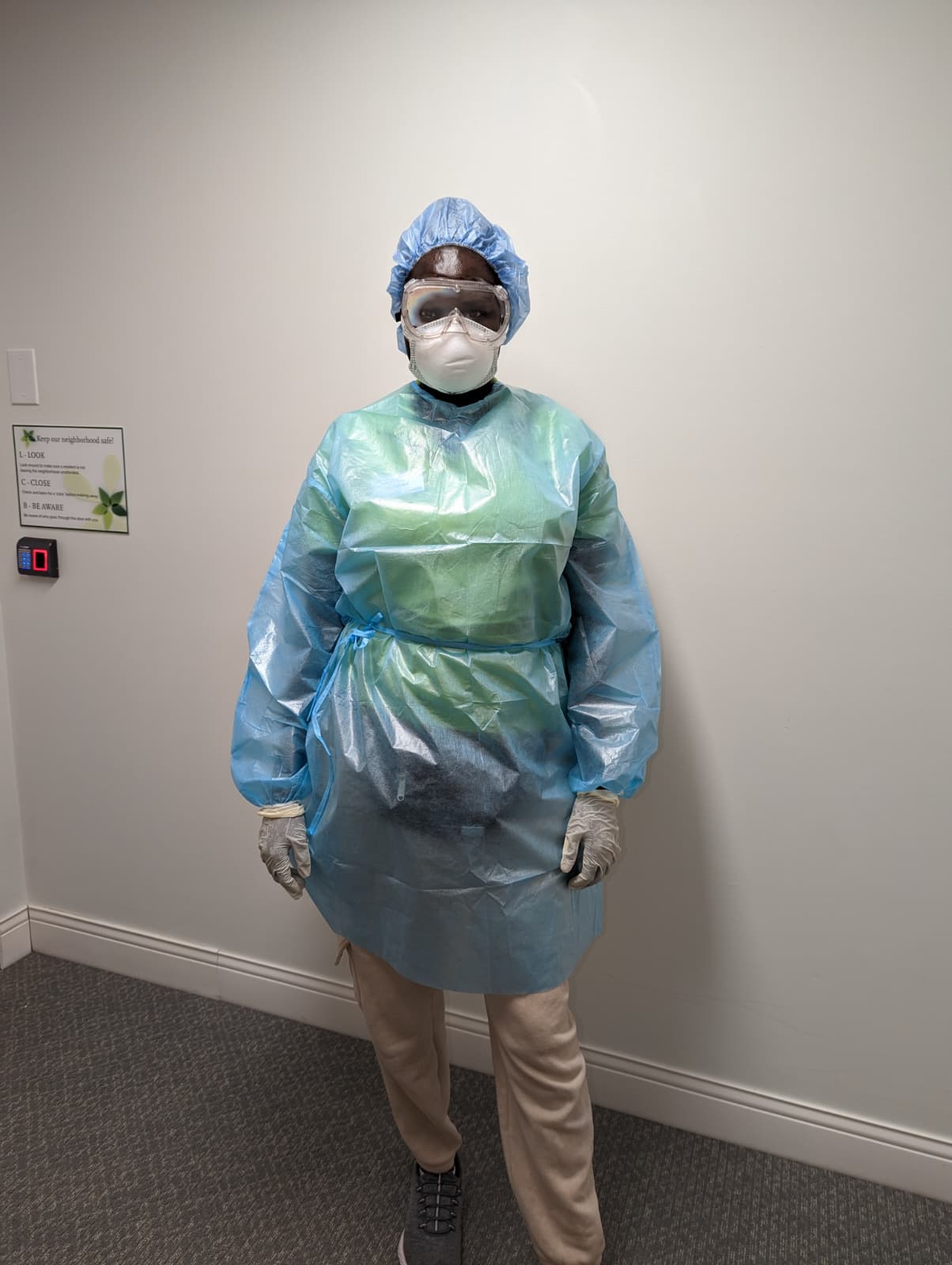A Selena M Barach caregiver in full PPE, ready for an infection-precaution visit.