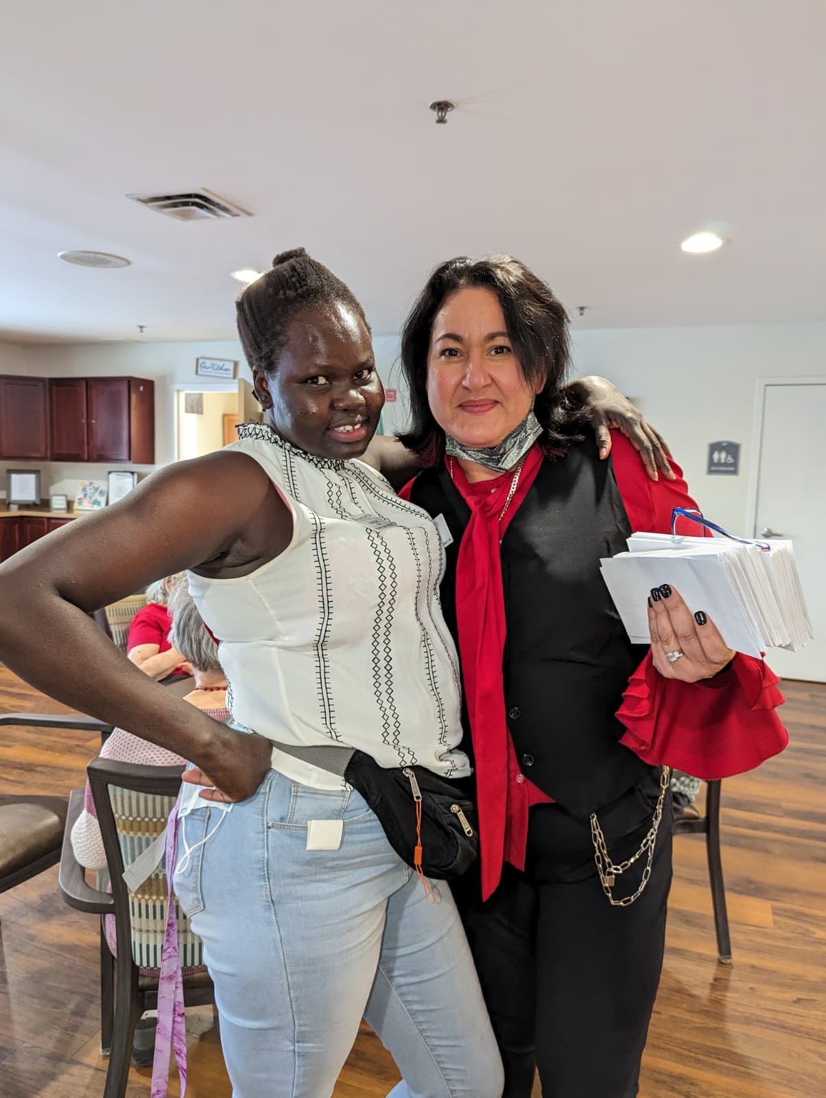 Selena and a caregiver arm-in-arm at a resident event.